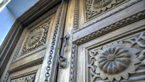 Traditional Zanzibar carved wooden door with chain and lotus flower symbols